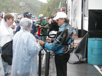 When John Force isn't racing, he's always busy signing autographs & mixing with the crowd!