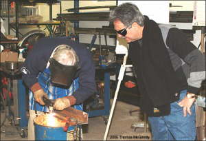 Tony looks on as Ward demonstrates the proper cutting technique.