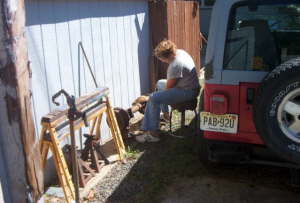 Becky using wire wheel on the rear diff