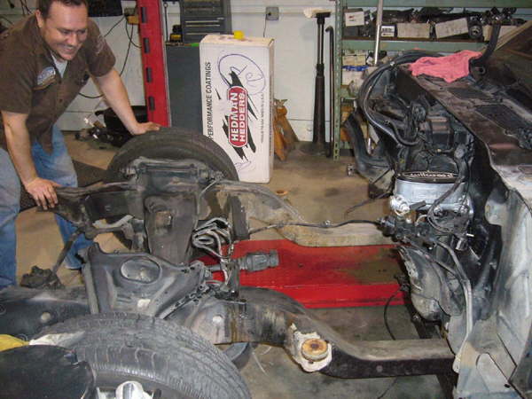 Subframe bolts removed, rolling out the old
