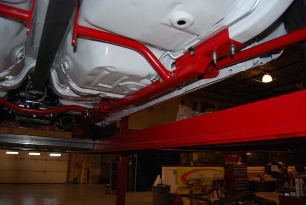 Optional subframe connectors, transmission, crossmember, drive shaft hoop bolted into place.